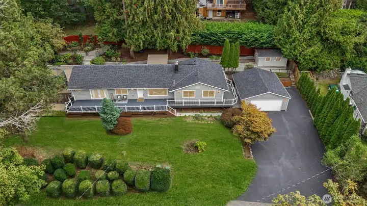 The Sammamish home sits gracefully on a private, tree-lined half-acre lot, set back from the quiet neighborhood street.