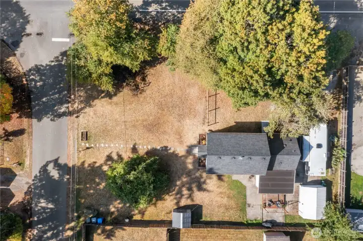 Bird’s-eye view of this historic 1910 home and its spacious lot. Once part of a thriving apple orchard with its own water tower, the large front yard today offers plenty of room to dream—gardens, play spaces, or even a future DADU