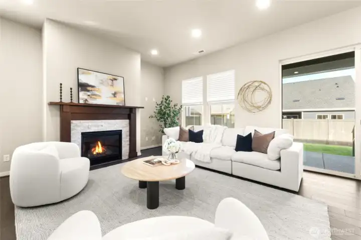 Cozy up by the gas fireplace in this stylish, open-concept living area.