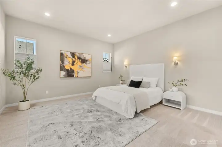 Wake up to soft light and peaceful surroundings in the primary bedroom.