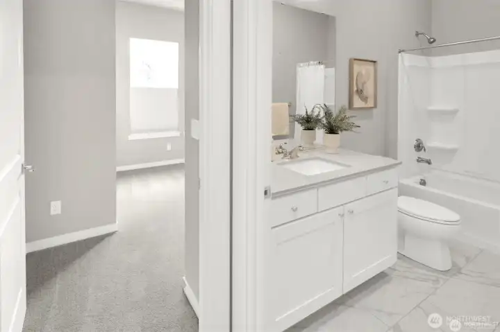Clean lines and neutral tones create a soothing second bath.
