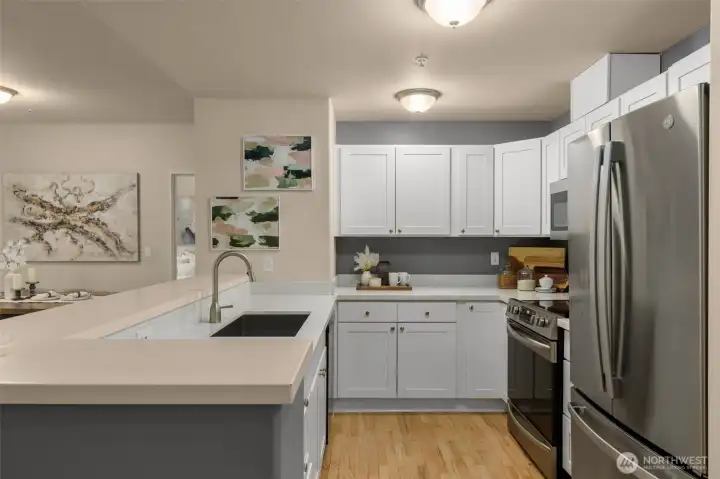 Spacious open kitchen with soft close drawers, granite countertops and stainless steel appliances.