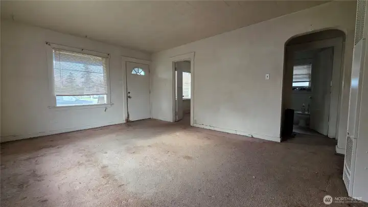 Extra large living room has two large windows letting tons of natural light in