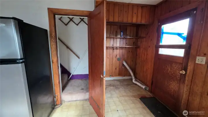 Stairs to 2nd floor off the kitchen - laundry hookups off the kitchen. Install stacking W/D and create room to extend stairs.