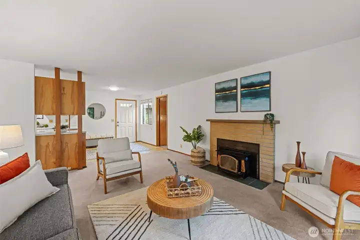 large inviting living room with fireplace (wood) to entry and kitchen