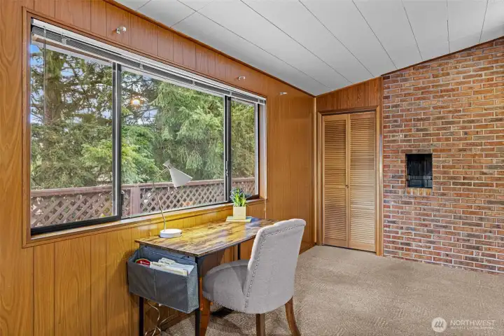 Closet and window overlooking side yard and deck