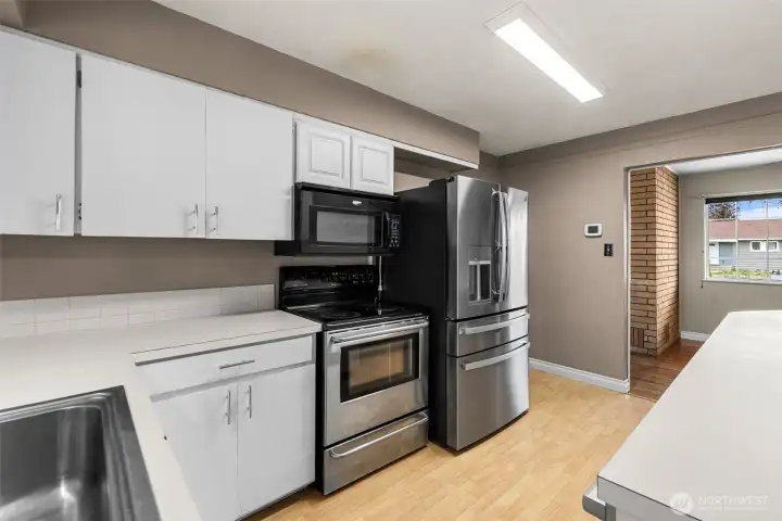 Kitchen with new stainless steel refrigerator