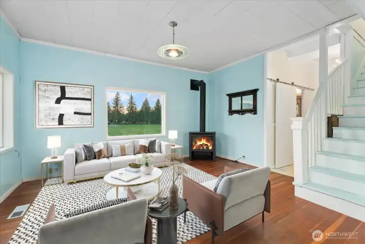 Recent updates blend naturally with the home's original character and charm, featuring a new propane fireplace, new windows, and refreshed paint. [Photo partially virtually staged.]