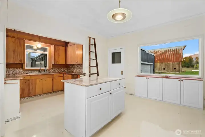 Main level, large bright, flowing kitchen with custom copper accents