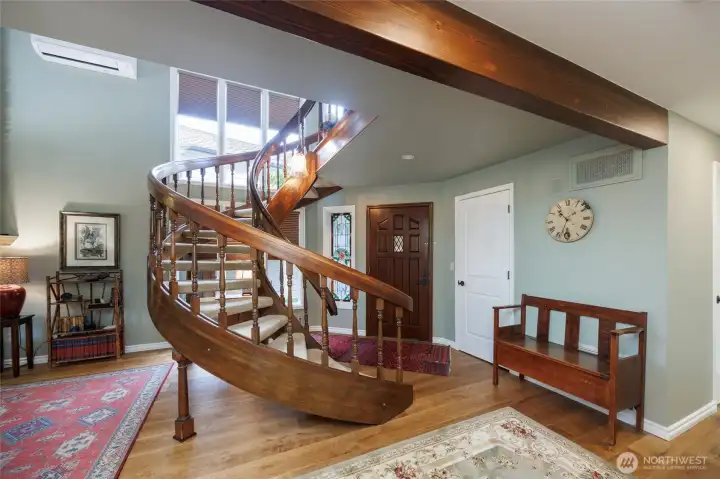 Unique entrance to home w/spiral staircase/finished wood beams and 9"x8'x3/4" oak plank floors on main level.