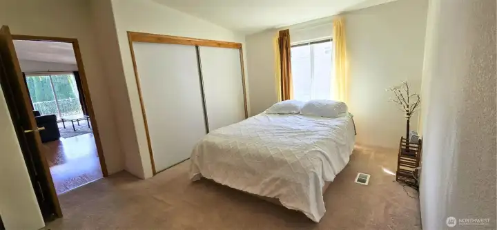 Primary bedroom and en-suite and with living room through door to the left