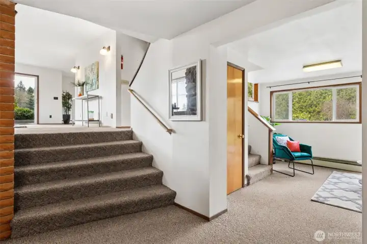 From the home's main entry on the left are steps that lead to the living room, the family room is to the right with steps that lead to kitchen, the door is access to the basement.