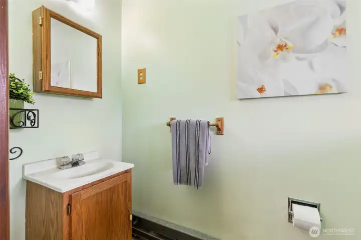 This is the powder room (half bath) located next to the main entry to home. Floor is linoleum.