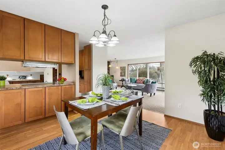 The dining room currently has a table for 4 and there is room for an expanded table to seat several more! The cabinets on the left offer storage for tableware. The dining room connects the kitchen and living room nicely. Laminate floors.