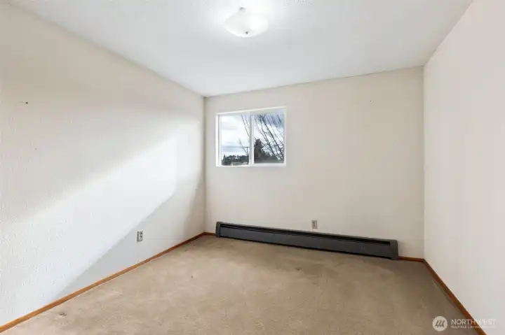 Bedroom #4. Carpeted flooring. View toward front yard. Located on 2nd floor of home.