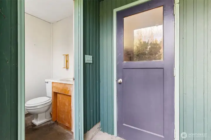 This half bath is great for access when you're too dirty from playing, gardening or working in the shop to go inside. Located off the back patio and next to the garage entrance. Concrete floor.