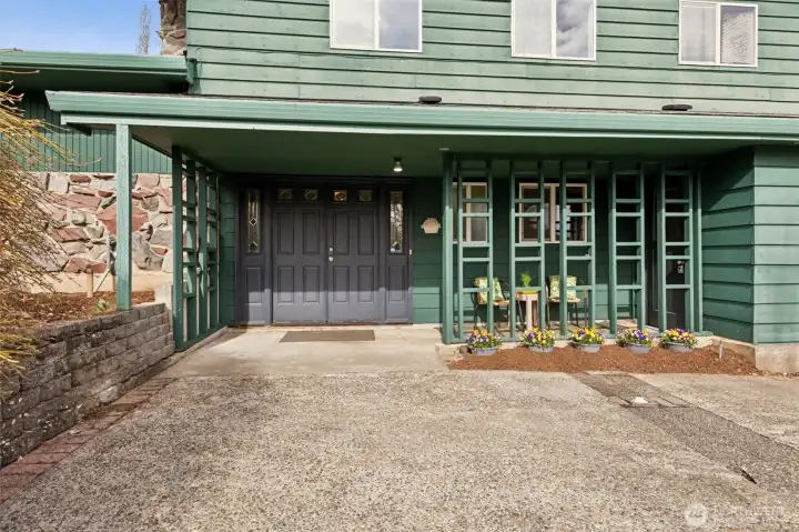 Entry to home features a breezeway...nice place to sit and enjoy your space and the activities of the rural neighborhood. There is an access doorway to the garage at right of breezeway.