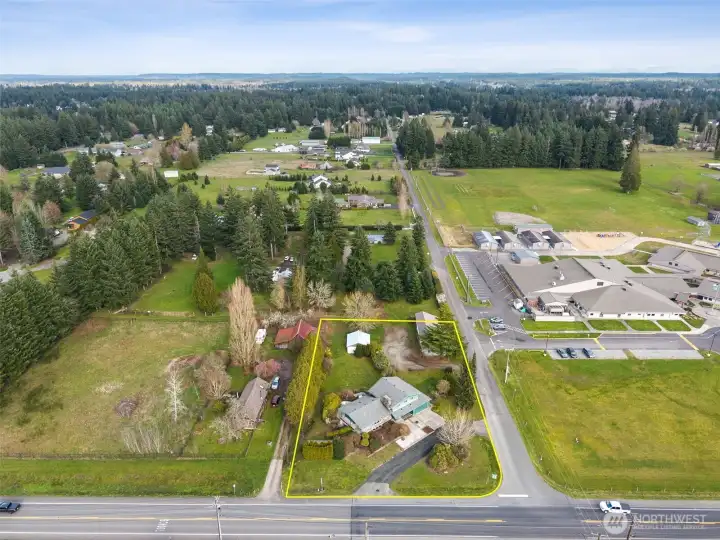 Overhead view captures a rough outline of the property (not exactly accurate). Showing the drive-through driveway; partially fence .82 acre yard with shop, tool shed. Across the street from East Olympia School.