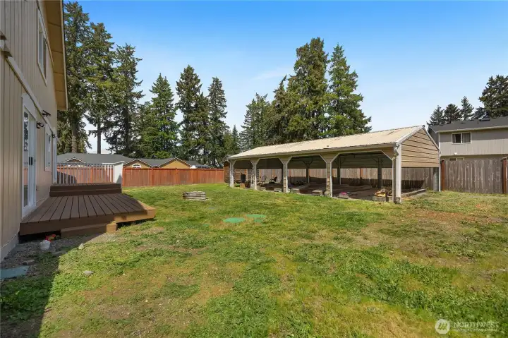 Enjoy the huge fenced backyard with deck space and a detached 4-car carport for parking, BBQs, or gatherings.