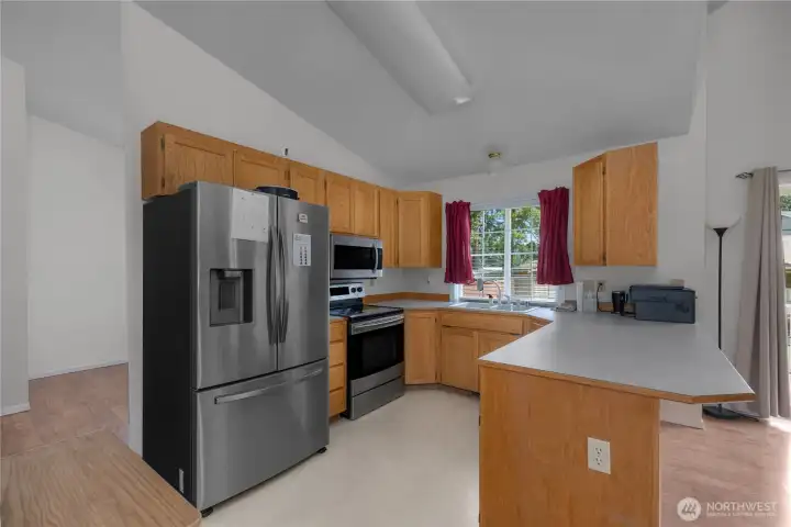 Cook and connect in the functional kitchen with stainless appliances and generous counter space.