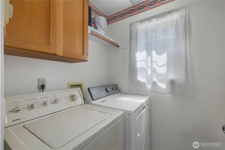 Stay organized with a dedicated laundry room offering storage and natural light.