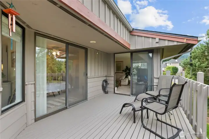 Large sliding doors connect the living room to the deck and bring the surrounding greenery indoors. Large sliding doors connect the living room to the deck and bring the surrounding greenery indoors.