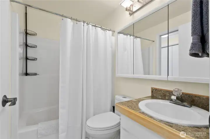 Bright and functional full guest bath with clean finishes, generous vanity storage, and an easy-care tub/shower combination. Bright and functional full guest bath with clean finishes, generous vanity storage, and an easy-care tub/shower combination.