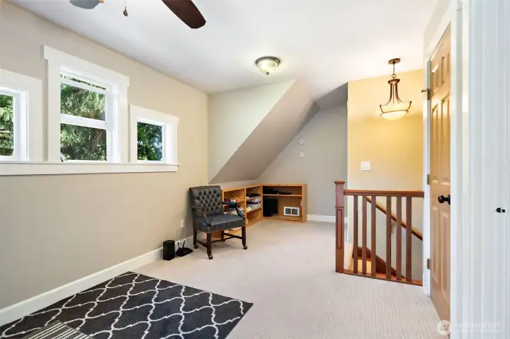 The top of the stairs opens into a spacious, light-filled landing that offers excellent flexibility. Perfect for a cozy reading nook, a homework station, or a secondary play area