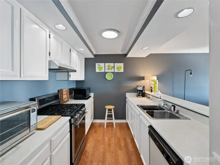 Convenient and well supplied galley style kitchen with great prep space. All appliances and  kitchen tools stay!!