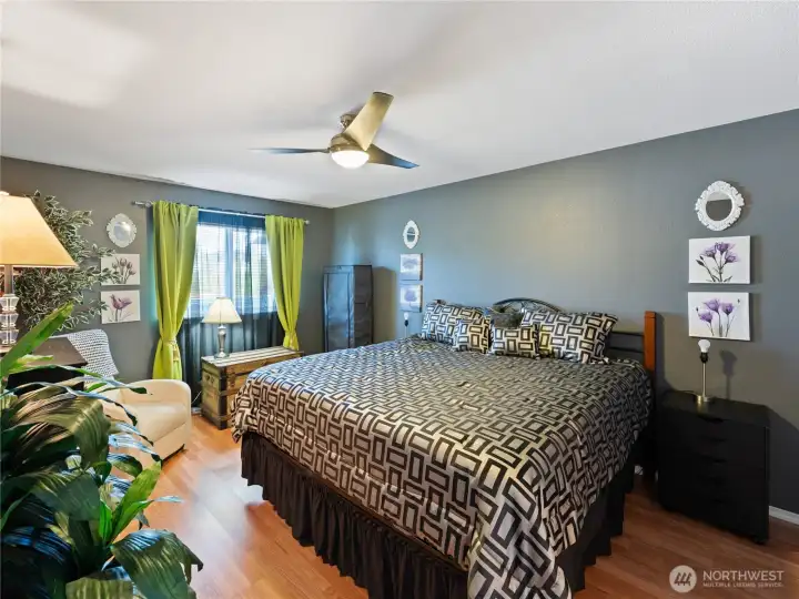 Spacious primary bedroom with fresh paint and newer LVP floors.