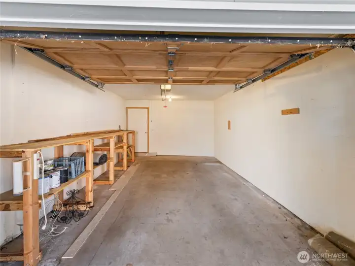 One car garage with workbench/storage area.