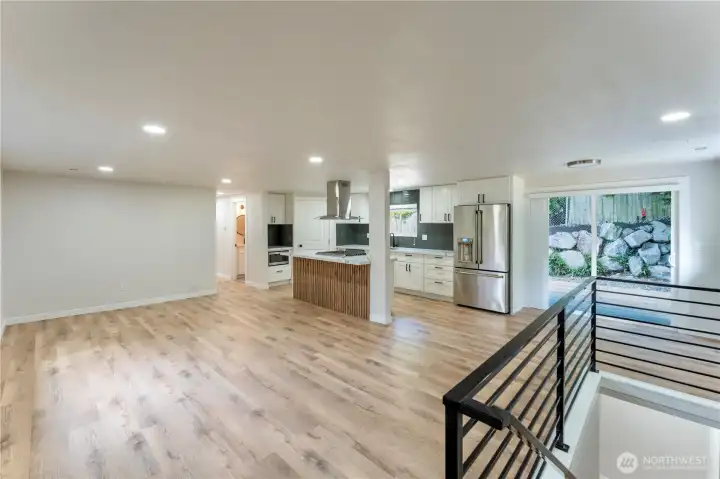 Kitchen showcasing custom metal railing leading to downstairs and sliding glass doors leading to your beautiful back patio