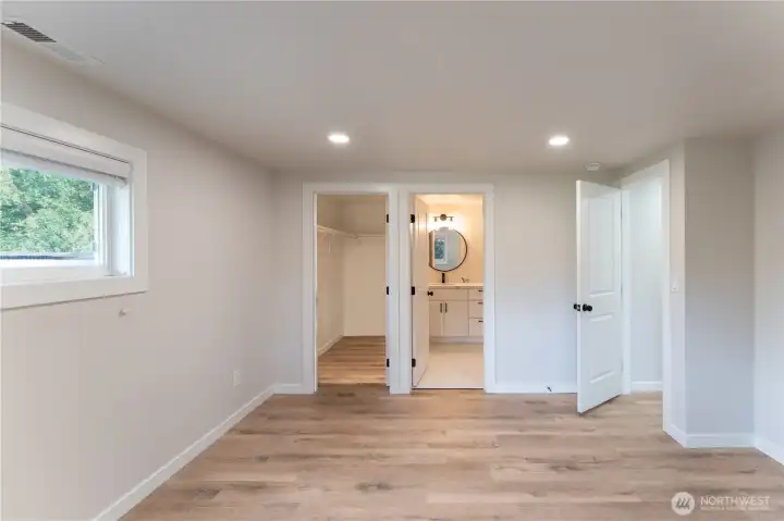 Primary bedroom showcasing walk in closet and ensuite bath