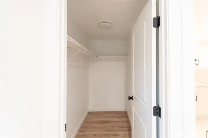 Primary bedroom walk in closet