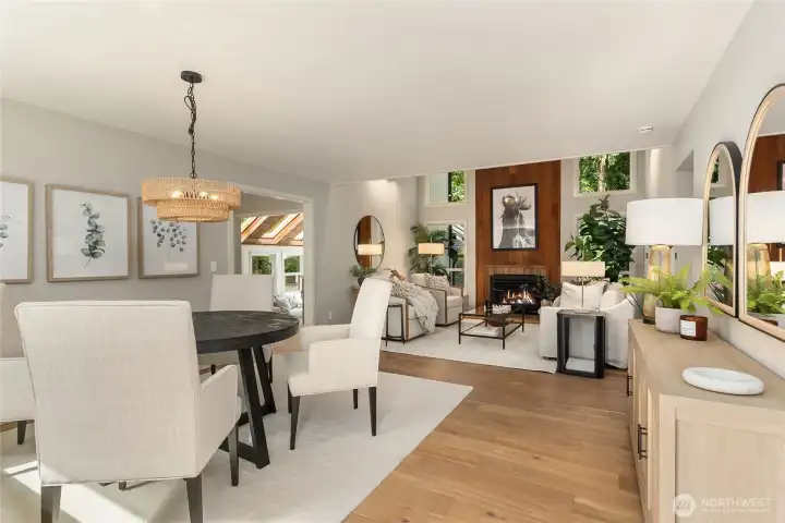 Welcome to this charming open-concept living space, where the dining room flows seamlessly into the vaulted great room—creating the perfect setting for entertaining and everyday living. Floor-to-ceiling windows surround the striking gas fireplace, filling the home with an abundance of natural light. Welcome to this charming open-concept living space, where the dining room flows seamlessly into the vaulted great room—creating the perfect setting for entertaining and everyday living. Floor-to-ceiling windows surround the striking gas fireplace, filling the home with an abundance of natural light.