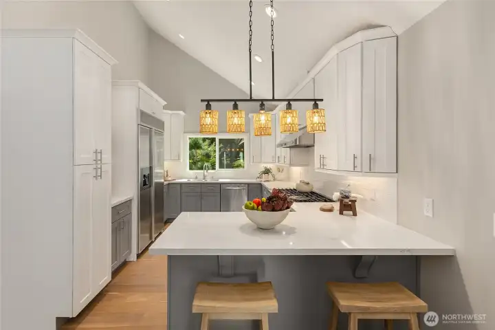 Designed to bring people together, the remodeled kitchen features a generous quartz island with seating, custom cabinetry, stainless steel appliances. Designed to bring people together, the remodeled kitchen features a generous quartz island with seating, custom cabinetry, stainless steel appliances.
