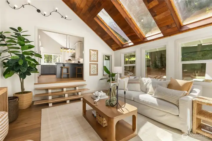 Sunlight pours into the space throughout the day, while sliding glass doors extend the living area into the adjoining sunroom, creating a seamless transition between indoor comfort and the surrounding natural beauty. Sunlight pours into the space throughout the day, while sliding glass doors extend the living area into the adjoining sunroom, creating a seamless transition between indoor comfort and the surrounding natural beauty.