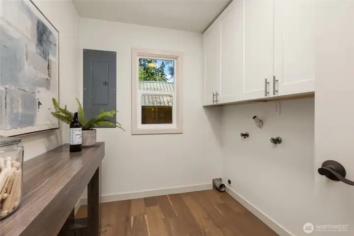 Dedicated laundry room with built-in cabinetry and natural light. Dedicated laundry room with built-in cabinetry and natural light.