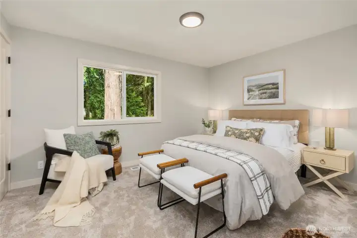 A peaceful guest bedroom overlooking the surrounding evergreens offers a quiet retreat with plush new carpeting and a calming, private setting. A peaceful guest bedroom overlooking the surrounding evergreens offers a quiet retreat with plush new carpeting and a calming, private setting.