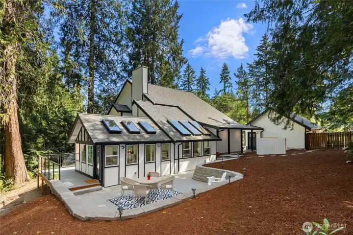 Surrounded by mature evergreens, the remodeled Northwest Contemporary showcases dramatic rooflines, expansive outdoor living spaces, and beautifully landscaped grounds designed for year-round enjoyment. Surrounded by mature evergreens, the remodeled Northwest Contemporary showcases dramatic rooflines, expansive outdoor living spaces, and beautifully landscaped grounds designed for year-round enjoyment.
