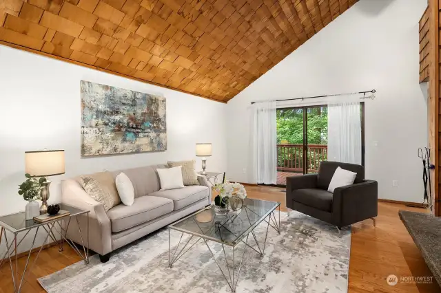 Living Room with vaulted ceiling and slider leading out to deck.