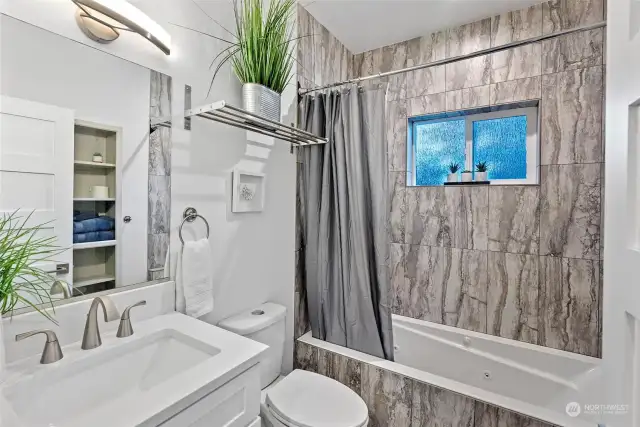 The full bath on the 2nd floor is outstanding. Ceramic tile floors, plenty of storage, and a jetted tub are the highlights of the room. The cool light fixtures brighten the room and an overhead towel rack is perfect for extra towels.