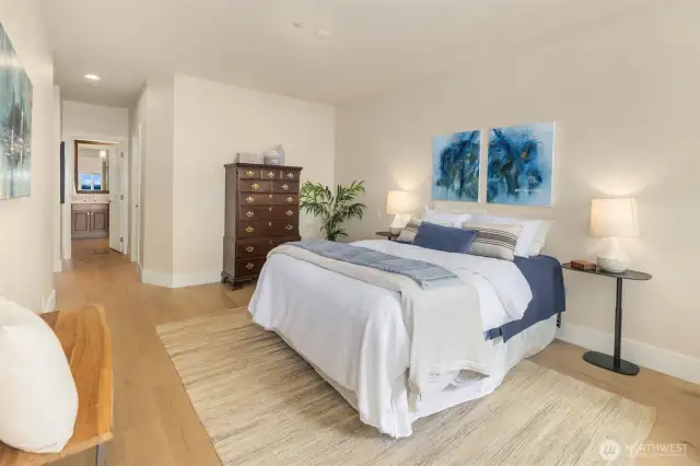 A spacious and serene primary suite with direct access to a luxe ensuite bath—your private retreat with room to recharge.