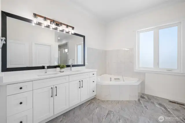 Expansive bathroom off the primary Master.  Dual sinks, soaking tub, toilet room, and walk-in shower.