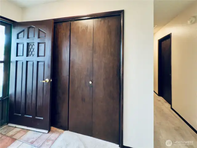View from living room to entryway and hallway to main bathroom and three bedrooms. Lots of built in storage.