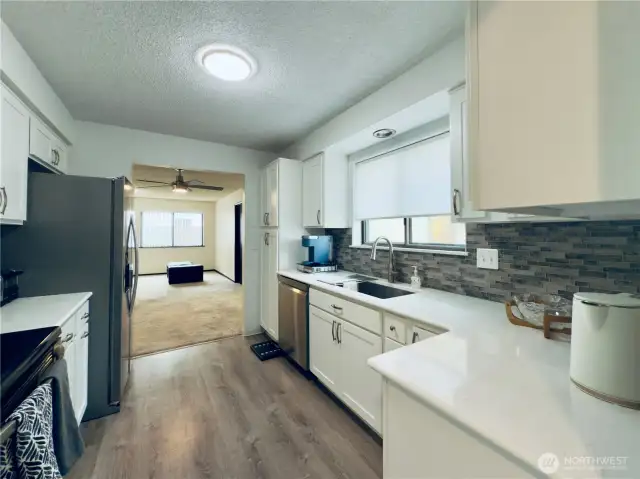 Updated kitchen, white cabinets with pull-out shelvings and pantry. Stainless steel appliances, easy access for entertaining.