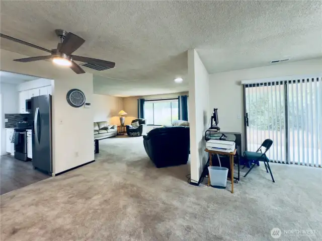 View from garage man door highlighting the kitchen, family/bonus room, dining room, and living room flow for great lvings