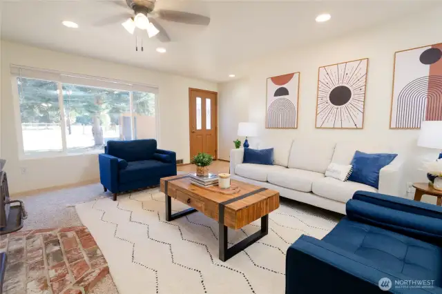 The cozy living room features a freestanding wood stove, adding warmth and charm while helping to offset heating costs during the colder months. The home also boasts fresh interior paint throughout, creating a clean, move-in-ready feel.