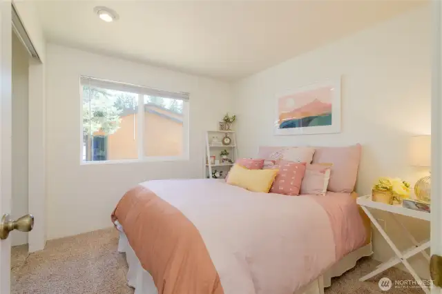 Bedroom #2 with soft, neutral carpet underfoot.