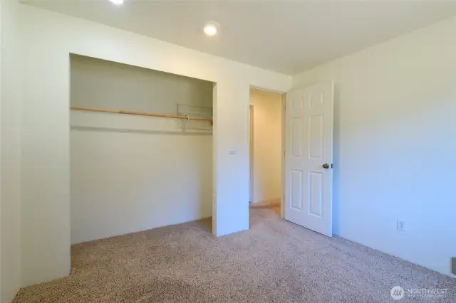 Bedroom #3 with fresh paint and soft neutral carpet underfoot.